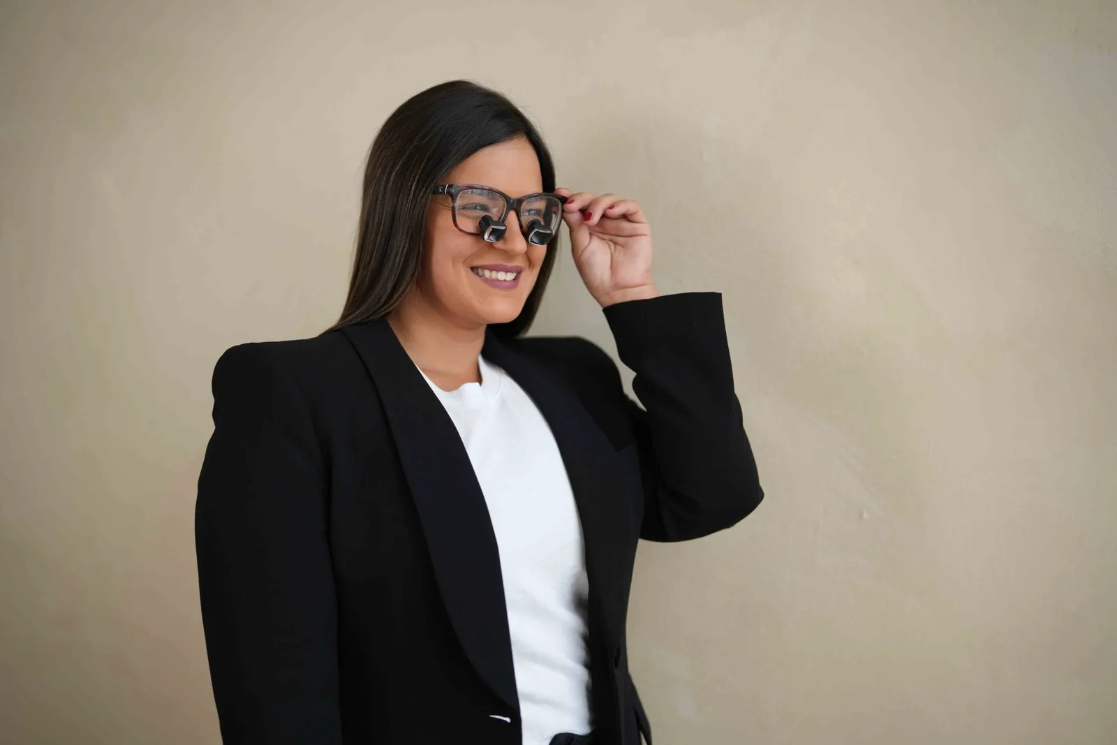 Dr. Andi-Jean Miro smiling in dental loupes over her glasses