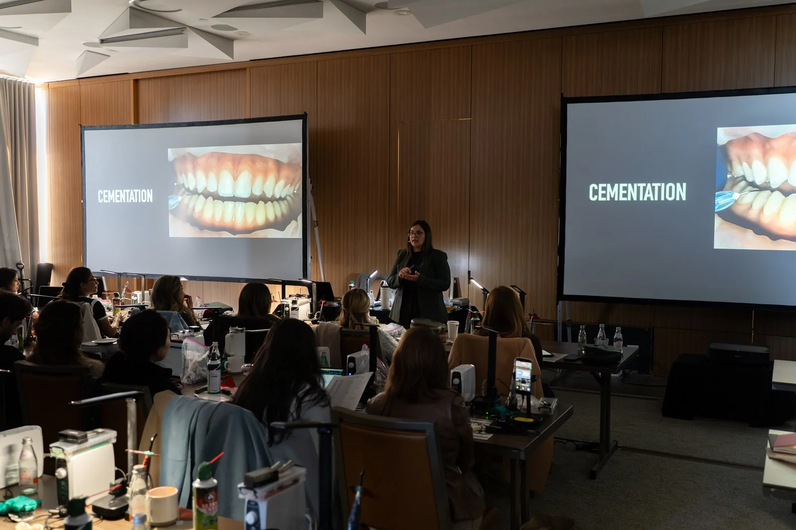 A cementation lecture at Art of Ceramic Los Angeles with an intraoral case on two screens