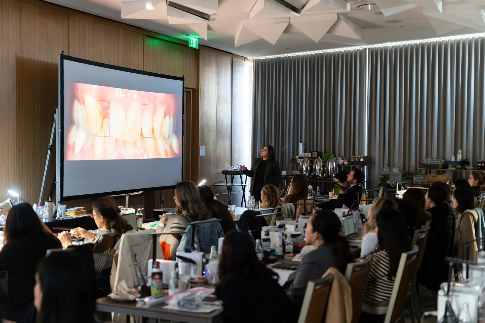 Wide view of a lecture at Art of Ceramic Los Angeles with intraoral photography on screen