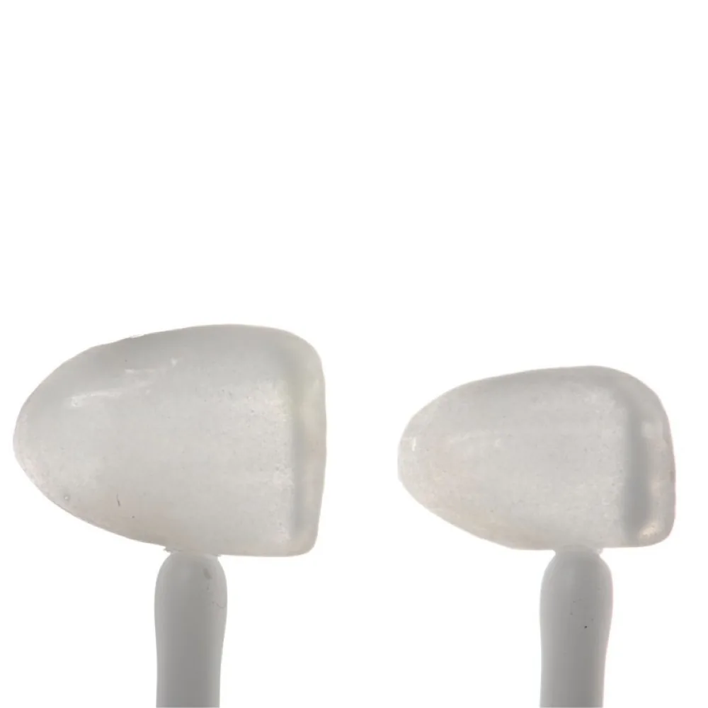 Two porcelain veneer samples on sticks, close-up
